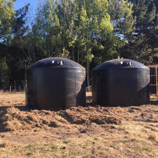 Two black 30,000 litre plastic water tanks